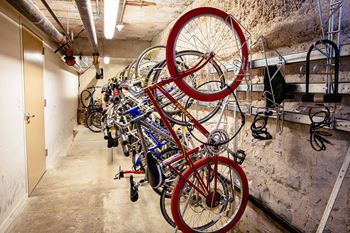 a row of bikes hanging on a wall in a garage